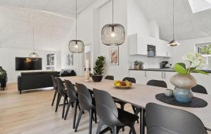 a dining room and living room with a table and chairs at Cozy Home In Glesborg With Sauna in Fjellerup