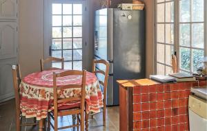 a kitchen with a table and a refrigerator at La Champêtre in Fayence