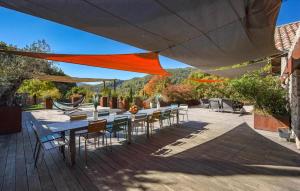 un patio con mesas y sillas bajo una sombrilla grande en Amazing Home In Genestelle, en Genestelle