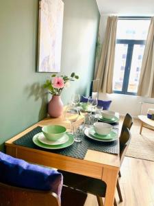 a dining room table with plates and wine glasses at Cozy Apartment in Antwerp central in Antwerp