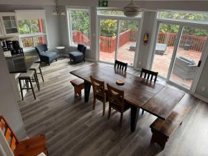 a living room with a wooden table and chairs at 5 Bedrooms, Mountain Views, Steps from Blue Mountain Village, Hot Tub, BBQ in Blue Mountains