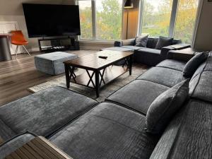 a living room with a couch and a table at 5 Bedrooms, Mountain Views, Steps from Blue Mountain Village, Hot Tub, BBQ in Blue Mountains