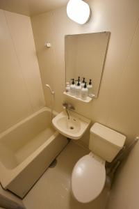 a bathroom with a toilet and a sink and a mirror at 1008 本町駅徒歩3分インペリアル快適ルーム 最大6名 in Osaka +25 photos