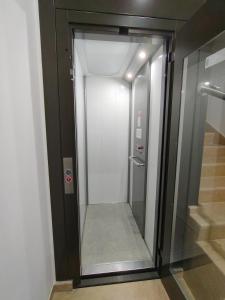 a walk in shower in a building with a glass door at La Luna e il Sole in Barletta