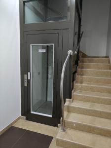 a staircase with a black door and stairs with a glass door at La Luna e il Sole in Barletta