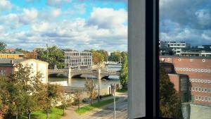 a view from a window of a bridge over a river at The Cyrus Hotel in Wrocław