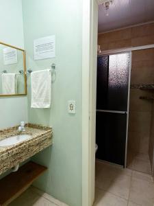 a bathroom with a sink and a shower at Pousada Lagoa dos Ventos in Barra de Ibiraquera +24 photos