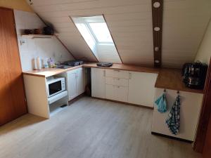 a small kitchen with a sink and a window at Krämer-Bude in Oberkrämer