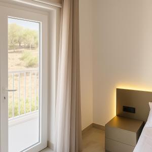 クレンディにあるPenelope Apartments 15のベッドと景色の見える窓のある寝室 +24枚の写真