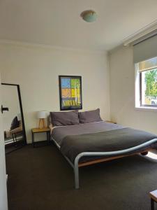 a bedroom with a large bed in a room at Quiet, Peaceful Northcote Unit in Melbourne
