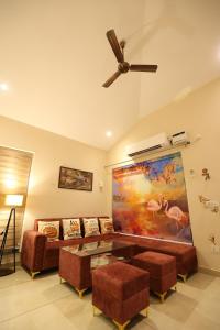 a living room with a couch and a ceiling fan at Sariska Bliss Farm, #2-BHK, #Private Pool & Garden in Alwar