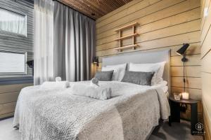 Postel nebo postele na pokoji v ubytování Levin Lyhty Beatrice by Hilla Villas