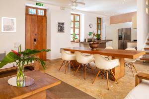 a kitchen and dining room with a wooden table and chairs at Billini Hotel, Historic Luxury in Santo Domingo