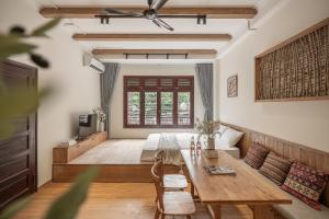 a living room with a table and a couch at Cozy StuHanoi Near Old Quarter in Hanoi