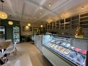 a bakery with a display case filled with pastries at Gästehaus Mack - Mosel Rooms & Restaurant in Trittenheim