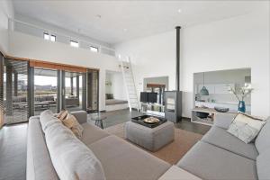 a large living room with a couch and a fireplace at Villa Super VIP | 4 Pers. (Villa 3) met privéstrand in Ouddorp