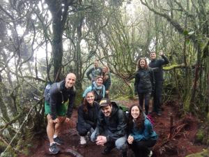 een groep mensen op een pad in het bos bij A3A Oastel CoLiving in Tanah Rata