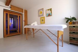 a white table in a room with a door at Sublime, hyper-centre d'Ajaccio, avec Spa, Sauna, Vue mer & Plage à 3min in Ajaccio +15 photos