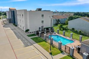 an apartment with a swimming pool and a building at Candlewood Suites Victoria by IHG in Victoria