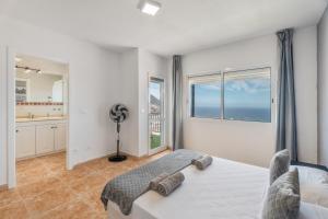 een slaapkamer met een bed en een groot raam bij Ocean View Costa Adeje in Adeje +26 foto's