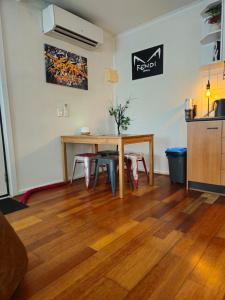 a dining room with a wooden table and chairs at Quiet, Peaceful Northcote Unit in Melbourne