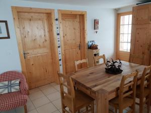 a dining room with a wooden table and chairs at Vieux Chalets B 03 in Grimentz