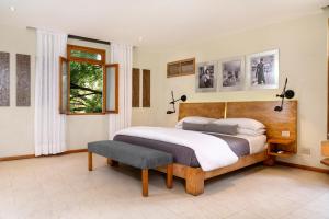 a bedroom with a large bed and a window at Billini Hotel, Historic Luxury in Santo Domingo