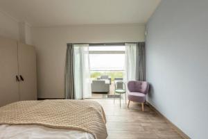 Ένα ή περισσότερα κρεβάτια σε δωμάτιο στο Beachfront Villa Deluxe 6p - Luxe & Uitzicht op het Grevelingenmeer - Villa 77