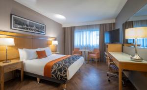 a hotel room with a bed and a desk and a computer at Clayton Hotel Liffey Valley in Clondalkin 