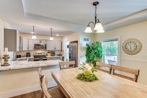a kitchen and dining room with a wooden table and chairs at 6 Mi to Notre Dame Family Retreat with Deck and Yard in Mishawaka