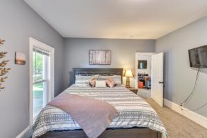 a bedroom with a large bed with blue walls at 6 Mi to Notre Dame Family Retreat with Deck and Yard in Mishawaka