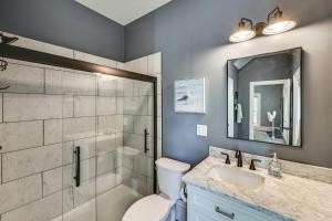 a bathroom with a toilet and a sink and a shower at 6 Mi to Notre Dame Family Retreat with Deck and Yard in Mishawaka +19 photos