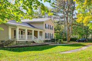 a house with a car parked in front of it at 6 Mi to Notre Dame Family Retreat with Deck and Yard in Mishawaka