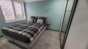 a bedroom with a bed with a mirror next to it at Ferienwohnung Nordstern in Papenburg