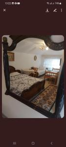 a bedroom with a bed with a wooden frame at Etno kuca Petrovic in Štrpce