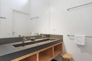 a bathroom with a sink and a mirror at Seaside Family Villa 6p - Direct bij het Strand - Villa 24 in Ouddorp +34 photos