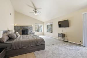 a bedroom with a bed and a flat screen tv at Spacious Mountain Getaway Game Room & Gazebo villa in Pine Mountain Club