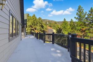 a balcony of a house with a fence and trees at Spacious Mountain Getaway Game Room & Gazebo villa in Pine Mountain Club +30 photos