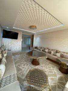a living room with a couch and a table at إقامة الرياض الأطلس in Beni Mellal
