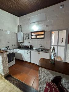 a kitchen with white cabinets and a counter top at Casa Bahia in Concepción del Uruguay