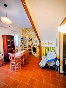 a dining room with a table and a fireplace at La Villetta di Odisseo in Terracina