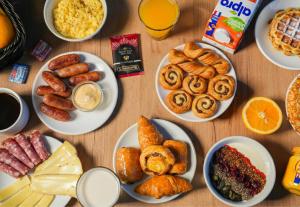 リールにあるB&B HOTEL Lille Lillenium Eurasantéの食べ物や飲み物の皿が置かれたテーブル