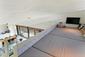 an overhead view of a living room with a staircase at Dune & Lakeview Villa 6p - Luxe, Lounge & Verwarmd Terras - Villa 30 in Ouddorp
