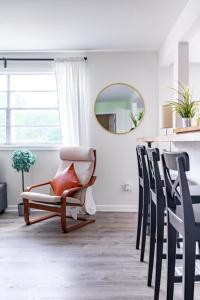 a living room with a chair and a mirror at Short North Convention Private Parking Pet in Columbus