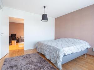 a white bedroom with a bed and a rug at Aurora Family Suite in Rovaniemi
