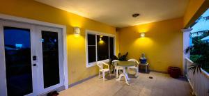 a room with a table and chairs and a window at Sun Wind Villa in Saint Johnʼs