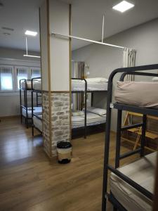 a row of bunk beds in a dorm room at Albergue Camiño Real in Sigüeiro