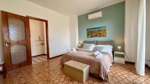 a bedroom with a large bed and a door at Mondello SunSea House in Mondello