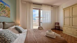 a bedroom with a large bed with towels on it at Mondello SunSea House in Mondello