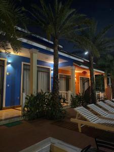 富国The Palm Phu Quoc Resort & Villa的棕榈树和夜间躺椅的度假村